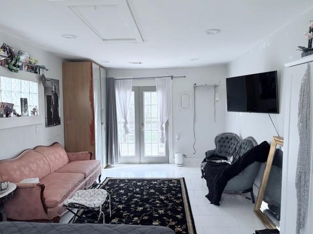 living room featuring french doors and attic access