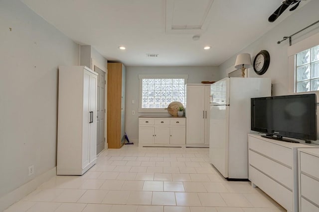 kitchen featuring white cabinets, recessed lighting, a healthy amount of sunlight, and freestanding refrigerator