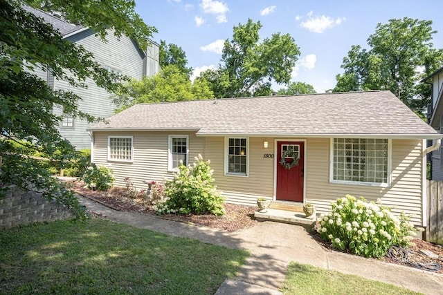 single story home with a shingled roof