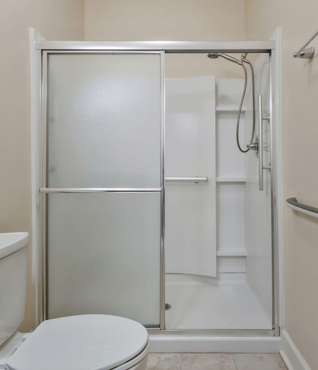 full bathroom with tile patterned flooring, a stall shower, and toilet