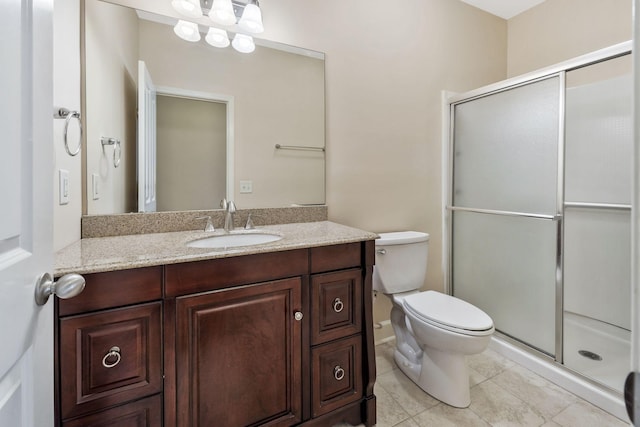 full bath with tile patterned floors, toilet, a stall shower, and vanity