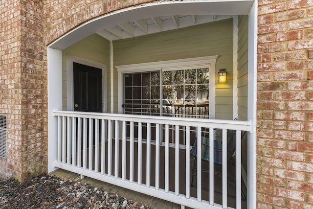 view of exterior entry featuring brick siding