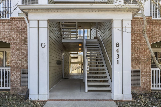 doorway to property featuring brick siding