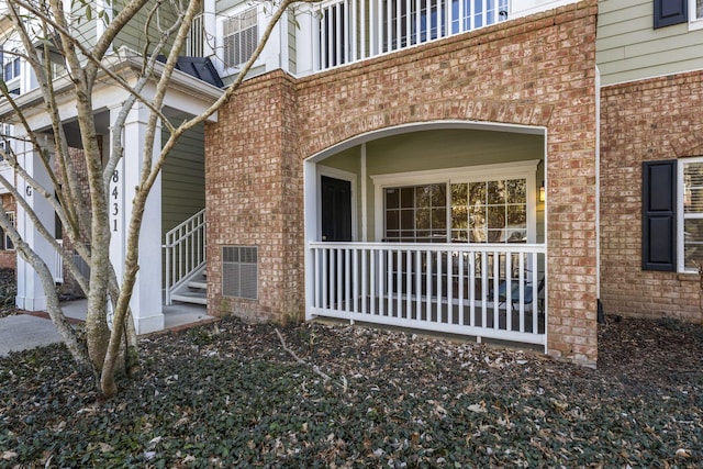 property entrance with brick siding