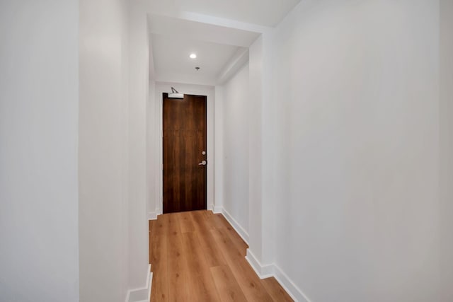 corridor with recessed lighting, light wood-type flooring, and baseboards