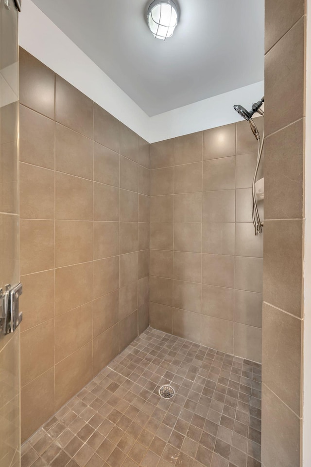 full bathroom with a tile shower