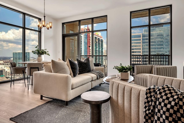 living room with a view of city, wood finished floors, and a chandelier