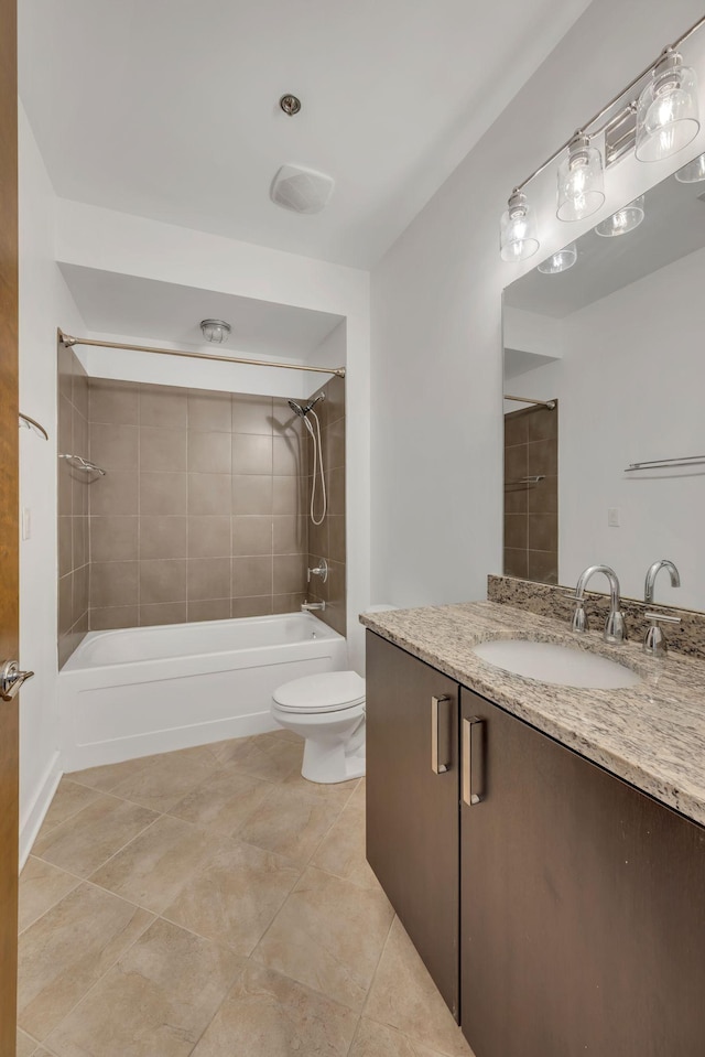 bathroom with tub / shower combination, toilet, vanity, and tile patterned flooring