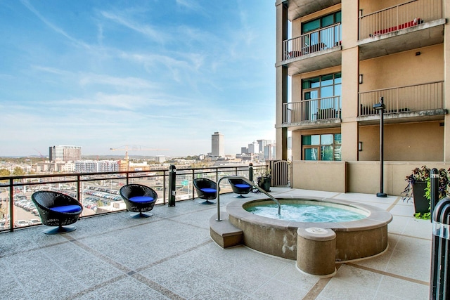 view of patio with a view of city and an in ground hot tub