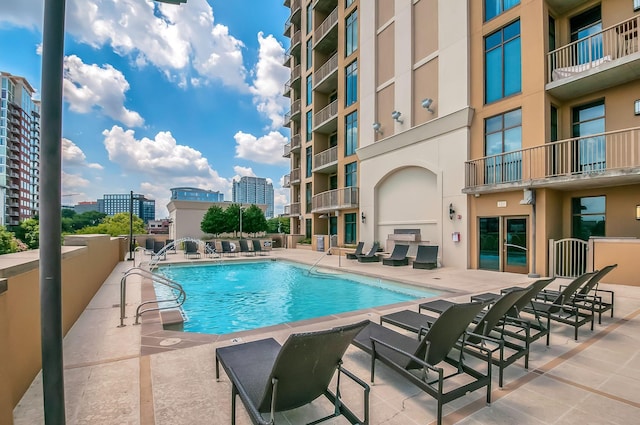 pool featuring a city view and a patio