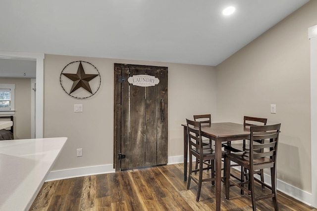 dining room with dark wood-type flooring and baseboards