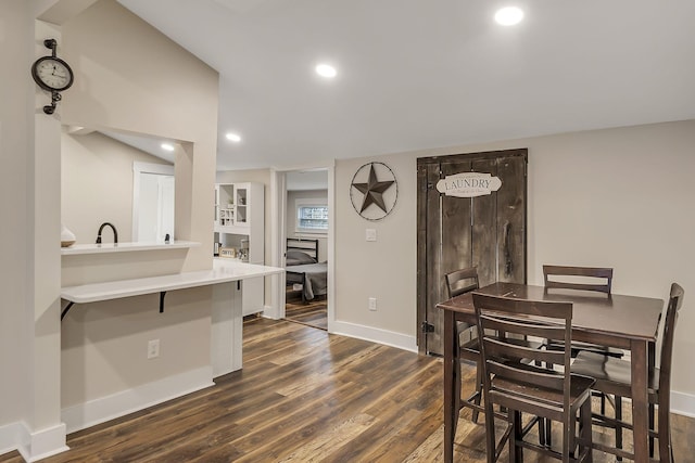 dining room with recessed lighting, dark wood-type flooring, and baseboards