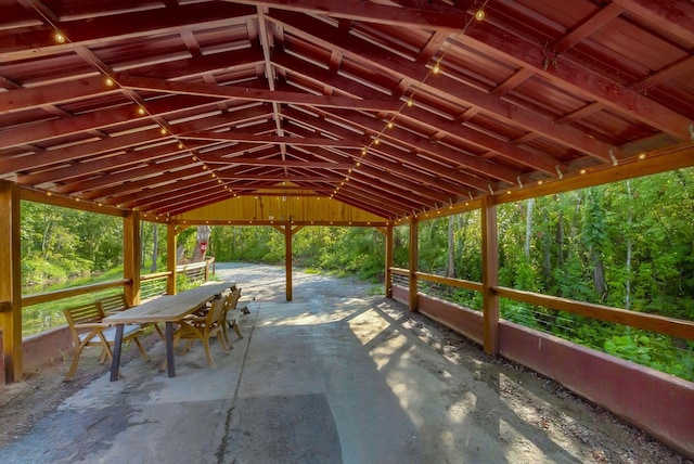 view of community featuring a forest view and a patio