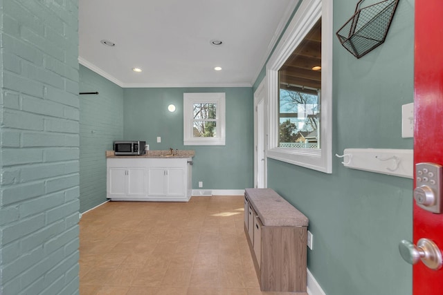 bathroom with visible vents, baseboards, ornamental molding, recessed lighting, and a sink