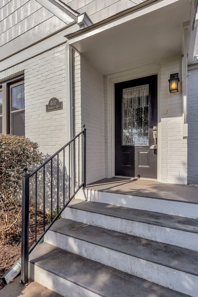 property entrance with brick siding