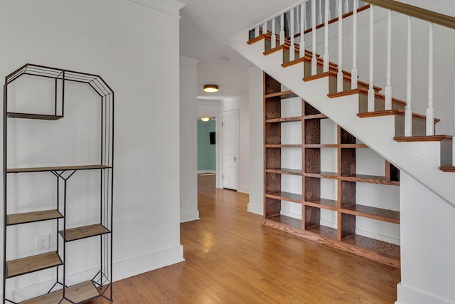 stairs with baseboards and wood finished floors