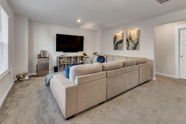 carpeted living area featuring recessed lighting, visible vents, and baseboards