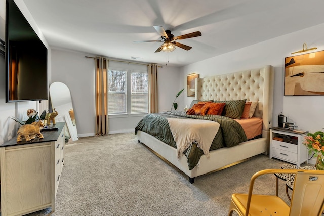 bedroom featuring baseboards, light colored carpet, and ceiling fan