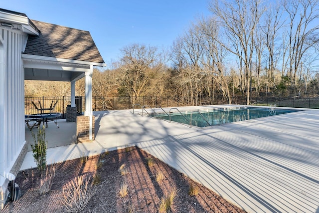 view of swimming pool featuring a fenced in pool, a patio, and fence