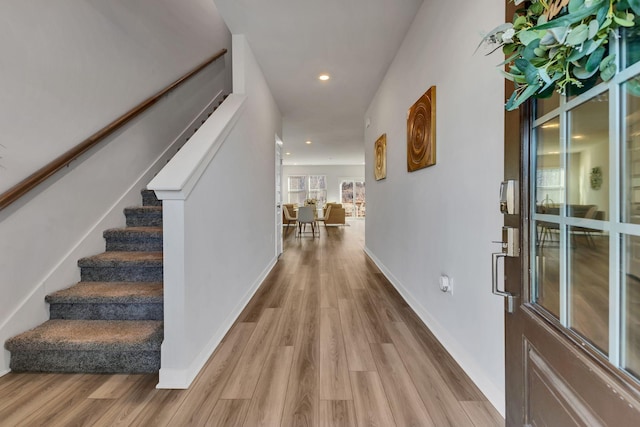 foyer featuring recessed lighting, stairway, baseboards, and wood finished floors