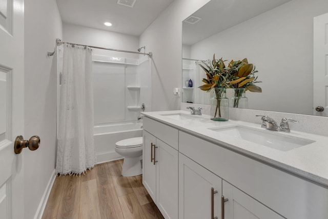 full bathroom with a sink, visible vents, toilet, and wood finished floors