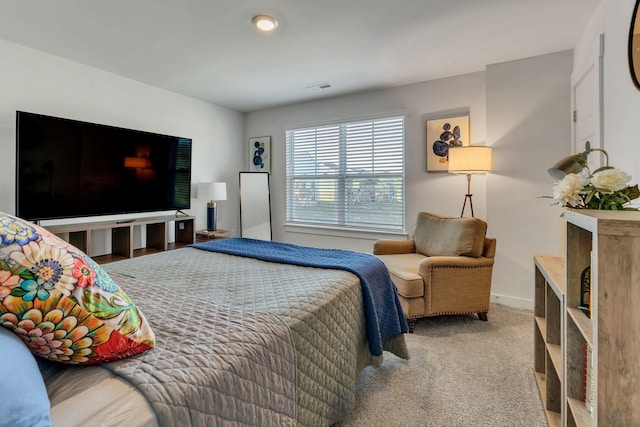 carpeted bedroom with baseboards and visible vents