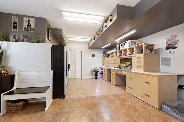 kitchen featuring light tile patterned floors, light brown cabinets, visible vents, open shelves, and light countertops