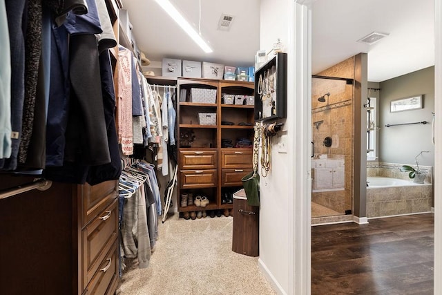 spacious closet featuring visible vents and wood finished floors