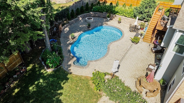 view of pool with a fenced in pool, stairway, a yard, a fenced backyard, and a patio area