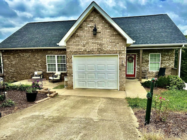 view of front of property with brick siding, driveway, an attached garage, and a shingled roof