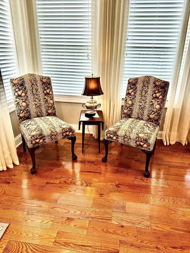 sitting room featuring baseboards and hardwood / wood-style flooring