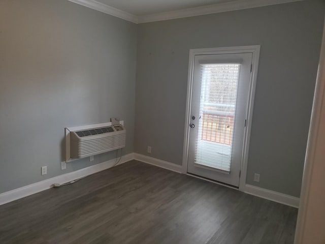 empty room with dark wood-style floors, an AC wall unit, baseboards, and ornamental molding