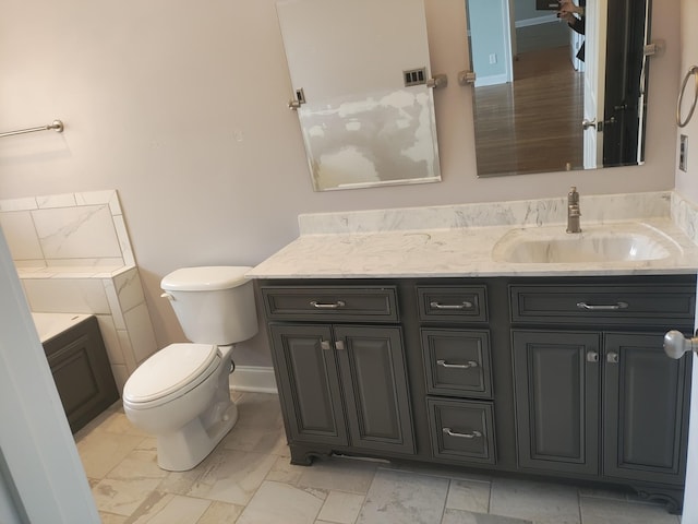 bathroom with visible vents, toilet, vanity, and marble finish floor