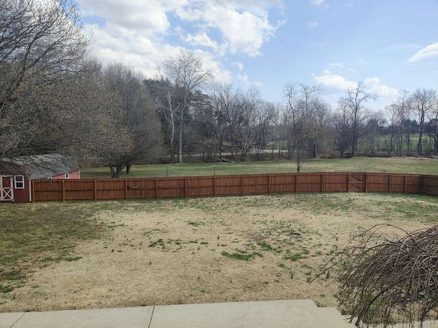 view of yard featuring an outdoor structure and fence