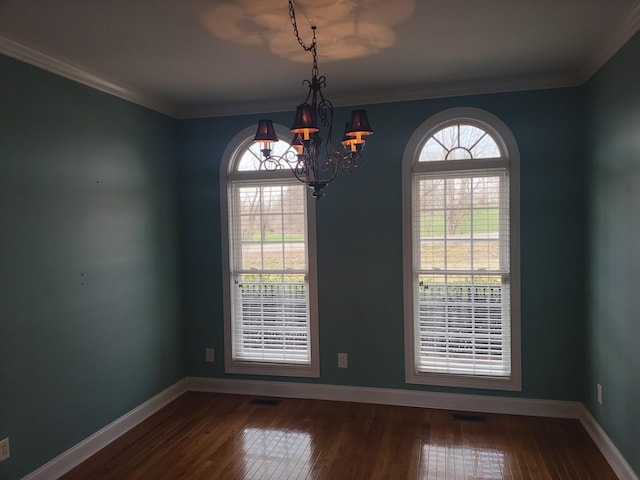 unfurnished room featuring an inviting chandelier, baseboards, and dark wood-type flooring