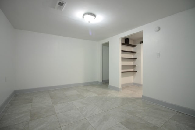 spare room featuring visible vents and baseboards