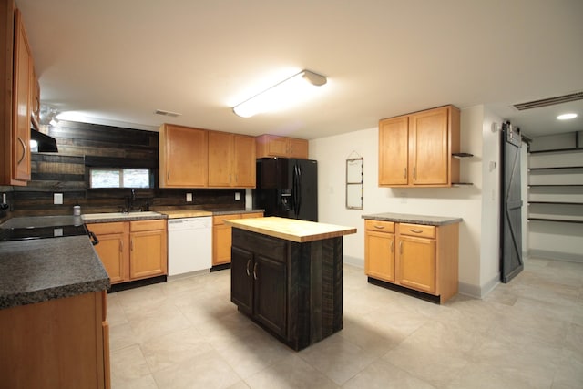 kitchen with visible vents, a barn door, range with electric stovetop, white dishwasher, and black fridge with ice dispenser