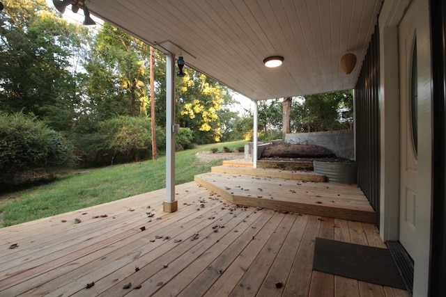 wooden terrace with a lawn