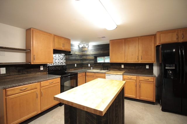 kitchen with open shelves, under cabinet range hood, black appliances, wood counters, and a sink