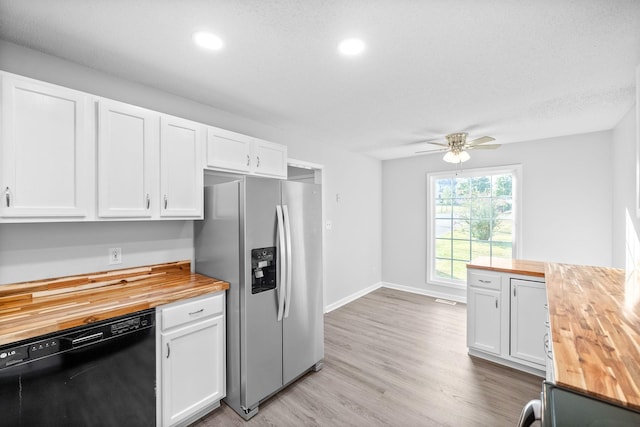 kitchen with stainless steel fridge, dishwasher, white cabinets, and wood counters