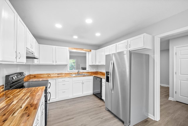 kitchen featuring under cabinet range hood, butcher block countertops, white cabinetry, and black appliances