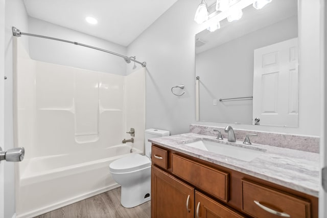 full bath with vanity, wood finished floors, visible vents, bathtub / shower combination, and toilet