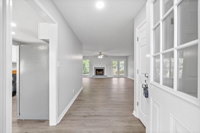 corridor with recessed lighting, baseboards, and wood finished floors