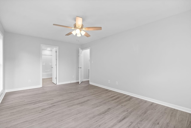 empty room featuring baseboards, light wood-style floors, and a ceiling fan