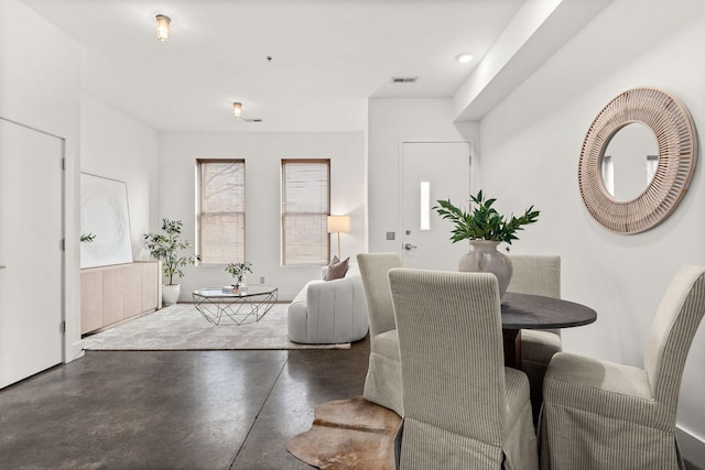 dining room featuring finished concrete flooring and visible vents