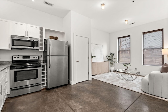 kitchen with visible vents, concrete flooring, appliances with stainless steel finishes, white cabinets, and open shelves