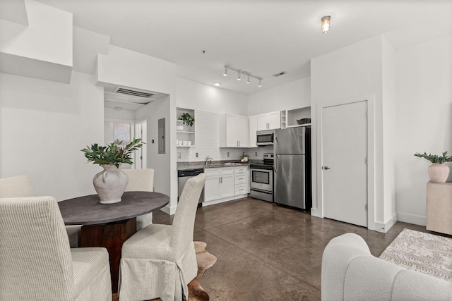 kitchen with visible vents, open shelves, finished concrete flooring, white cabinetry, and stainless steel appliances