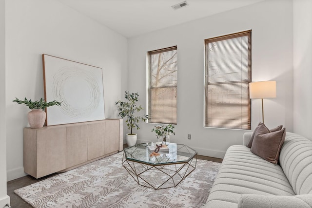 living room featuring visible vents and baseboards