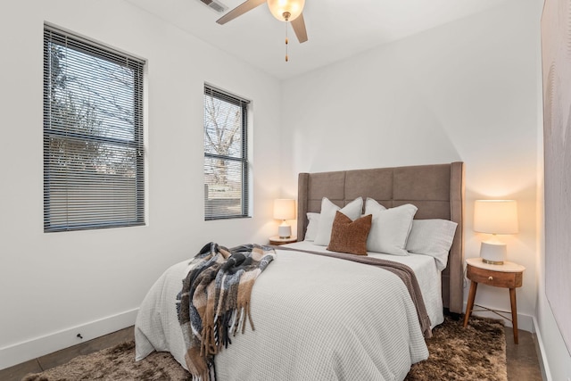 bedroom with a ceiling fan and baseboards