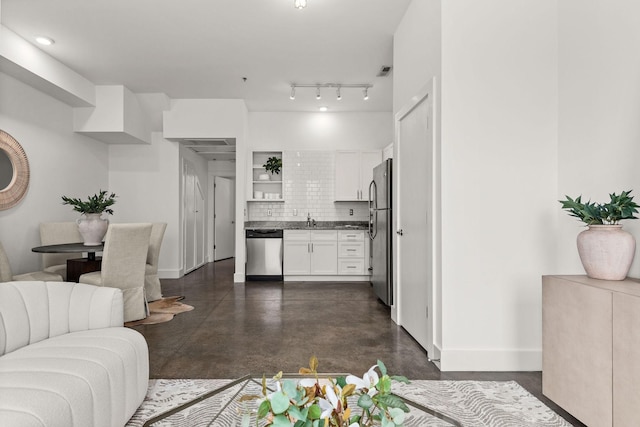 living area with visible vents, baseboards, and concrete floors